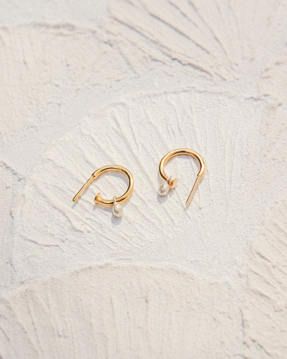 Mini hoop earrings with a gemstone.